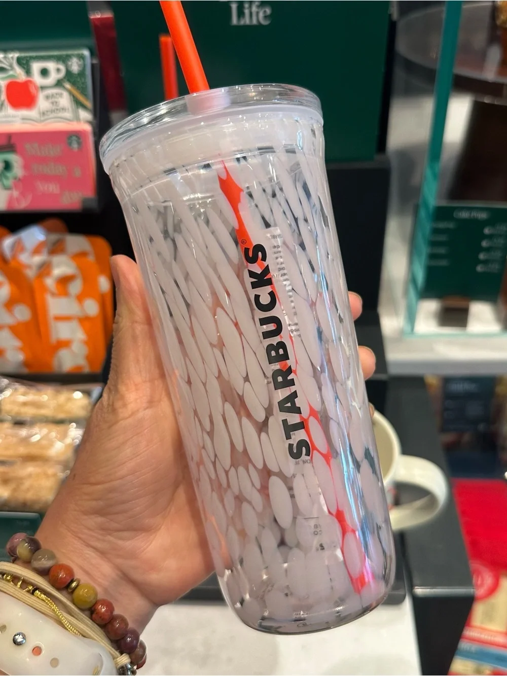 Starbucks 16-ounce PSL glass cold cup pumpkin detail with a matching straw.